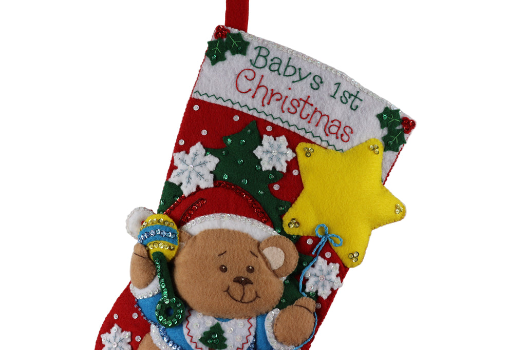 Baby's first Christmas stocking with a teddy bear design on a white background