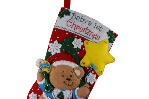 Baby's first Christmas stocking with a teddy bear design on a white background