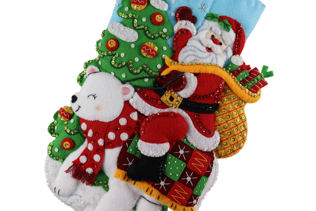 Decorative Christmas stocking with Santa Claus, polar bear, and Christmas tree design on a white background.