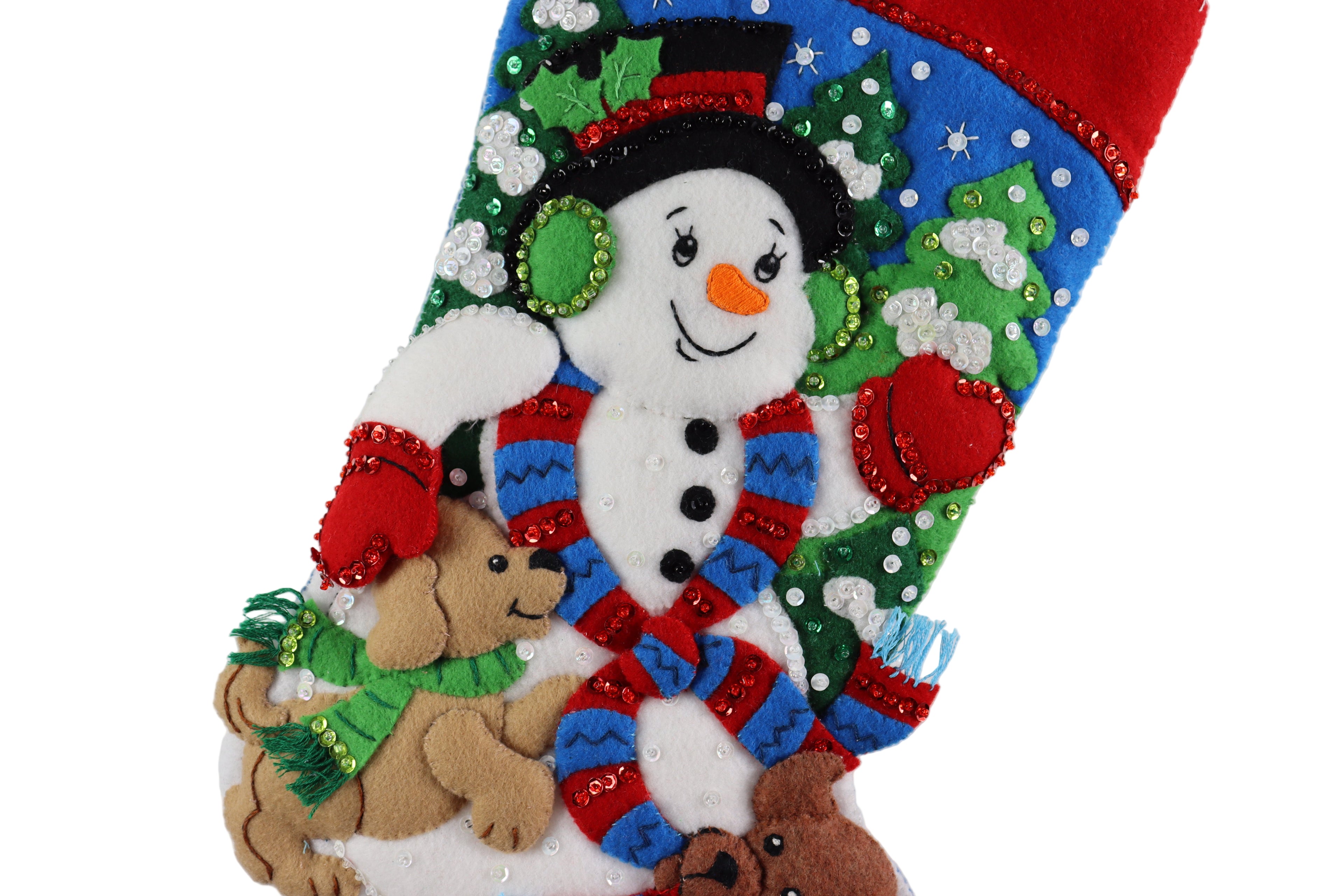 Felt Christmas stocking with snowman and dog design on a white background