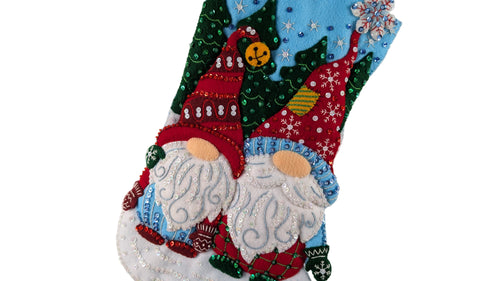 Decorative stocking with embroidered gnomes on a white background